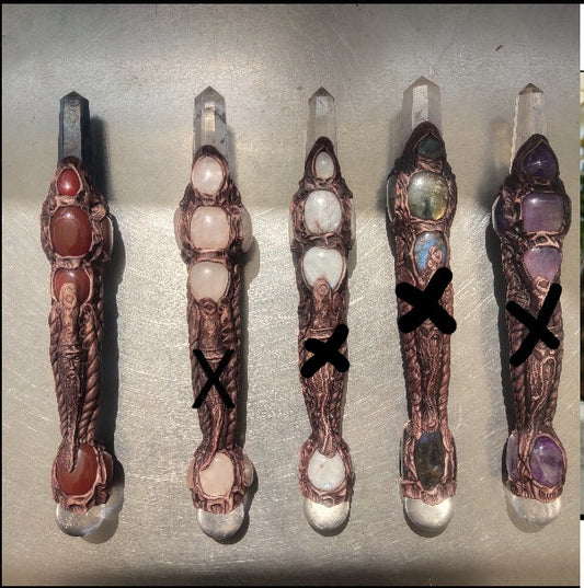 Set of five decorative handles with gemstones on a metallic surface