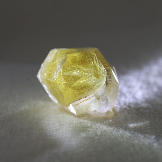 Quartz rutile cluster with golden needle-like rutile inclusions and multiple crystal points, symbolizing clarity, manifestation, and energy amplification
