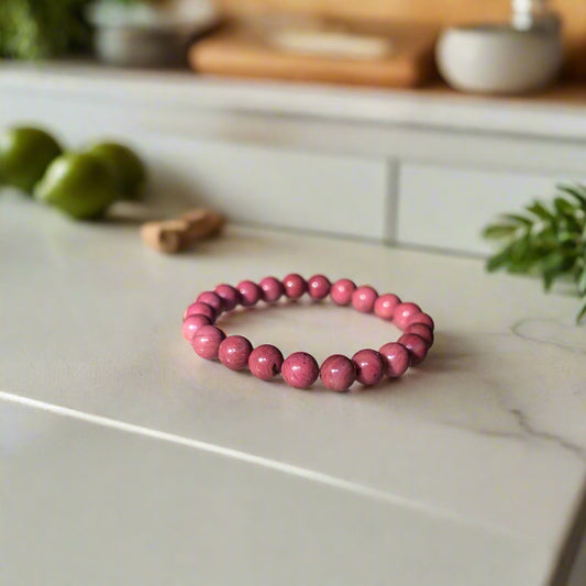 Thulite bracelet with polished pink stones, symbolizing compassion, self-love, and emotional healing