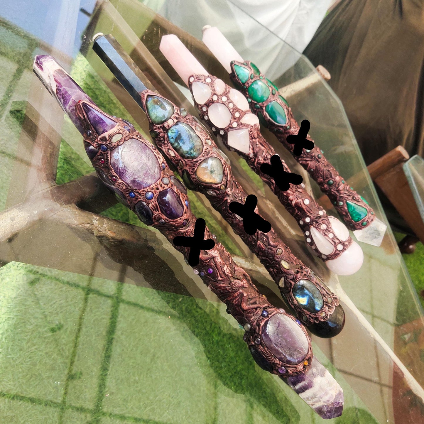 Decorative hair sticks with gemstones on a glass surface