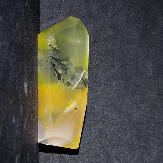 Crystal with yellow and green hues on a dark background
