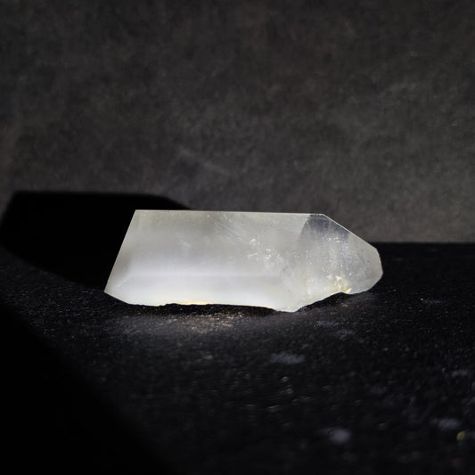 Clear crystal on a dark textured surface