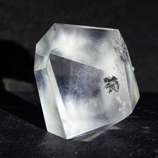 Clear crystal with a logo on a dark background