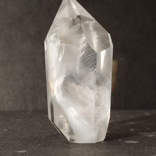 Clear crystal with natural patterns on a dark surface