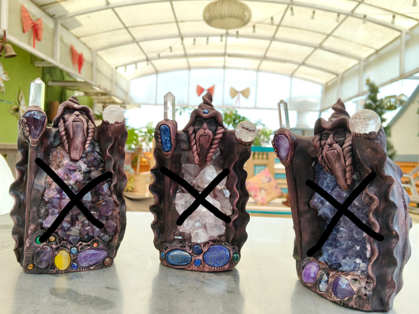 Three decorative figurines with a blurred indoor background