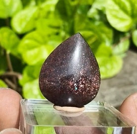 Bloodshot Sunstone Freeform – a polished gemstone with fiery red and golden inclusions, radiating warm shimmer and vitality